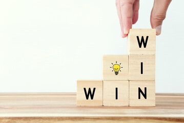 blocks stacked in a stair step spelling WIN on each edge